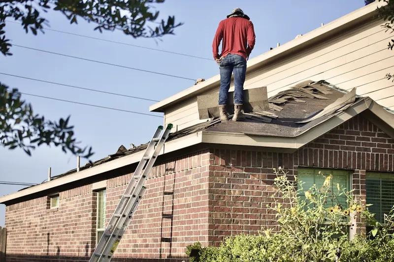 Professional roofer working on a residential roof in Shalimar